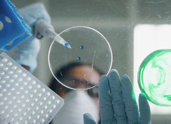 Alternative-shot-of-female-scientist-is-analyzing-with-a-pipette-a-liquid-to-extract