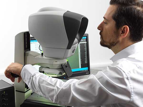 Man operating a Swift Pro Duo measuring microscope